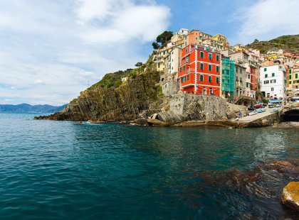 View of the colourful houses that line the coastline of the Cinque Terre shore clifff-face in Italy.