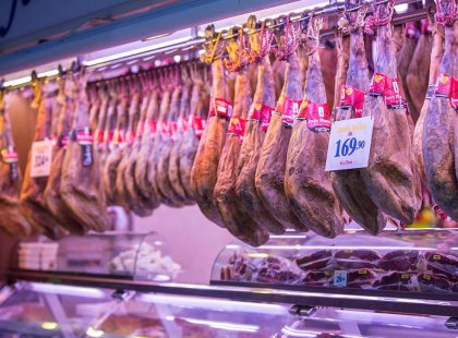 Jamon and other cured meats hanging in a local market in Barcelona, Spain.