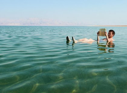 Relax and read a book while you float around in the Dead Sea