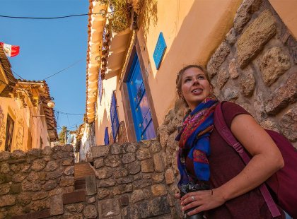 Traveller woman exploring cobbled streets of Cusco, Peru