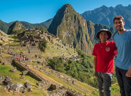 Traveller and Intrepid tour leader standing Machu Picchu, Peru