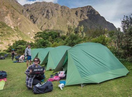 Travellers preparing before a night of camping along the Inca Trail in Peru on an Intrepid Travel tour