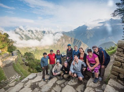 Group of travellers with view of Machu Picchu, Peru