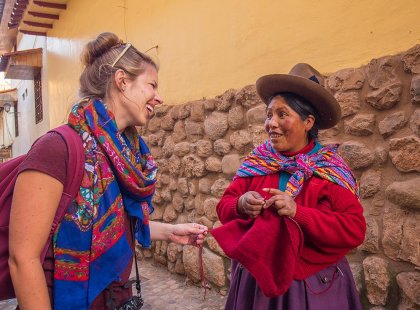 Traveller and local woman in traditional dress, Cusco, Peru