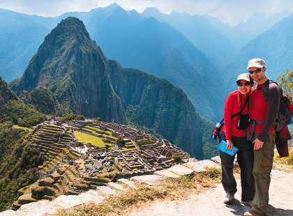 Traveller couple standing with view of Machu Picchu, Peru