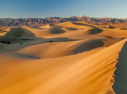 Take a sunset stroll on the golden Mesquite Flats Sand Dunes.
