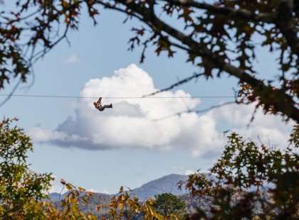 Zip-liners soar high above the forest on a heart pounding, two-mile, mountain-to-mountain ride.