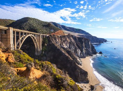 The approach to the Bixby Bridge on the Pacific Coast Highway 1, opens to the rocky shoreline characteristic of the area.