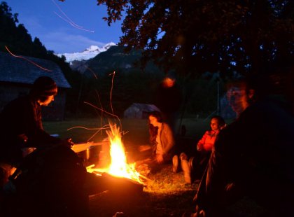 Travellers sitting around the campfire at night